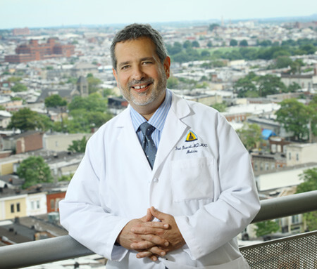 Photo of Dr. Brancati in a lab coat