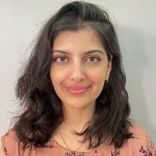 Sarah Syed smiles for a professional photo.