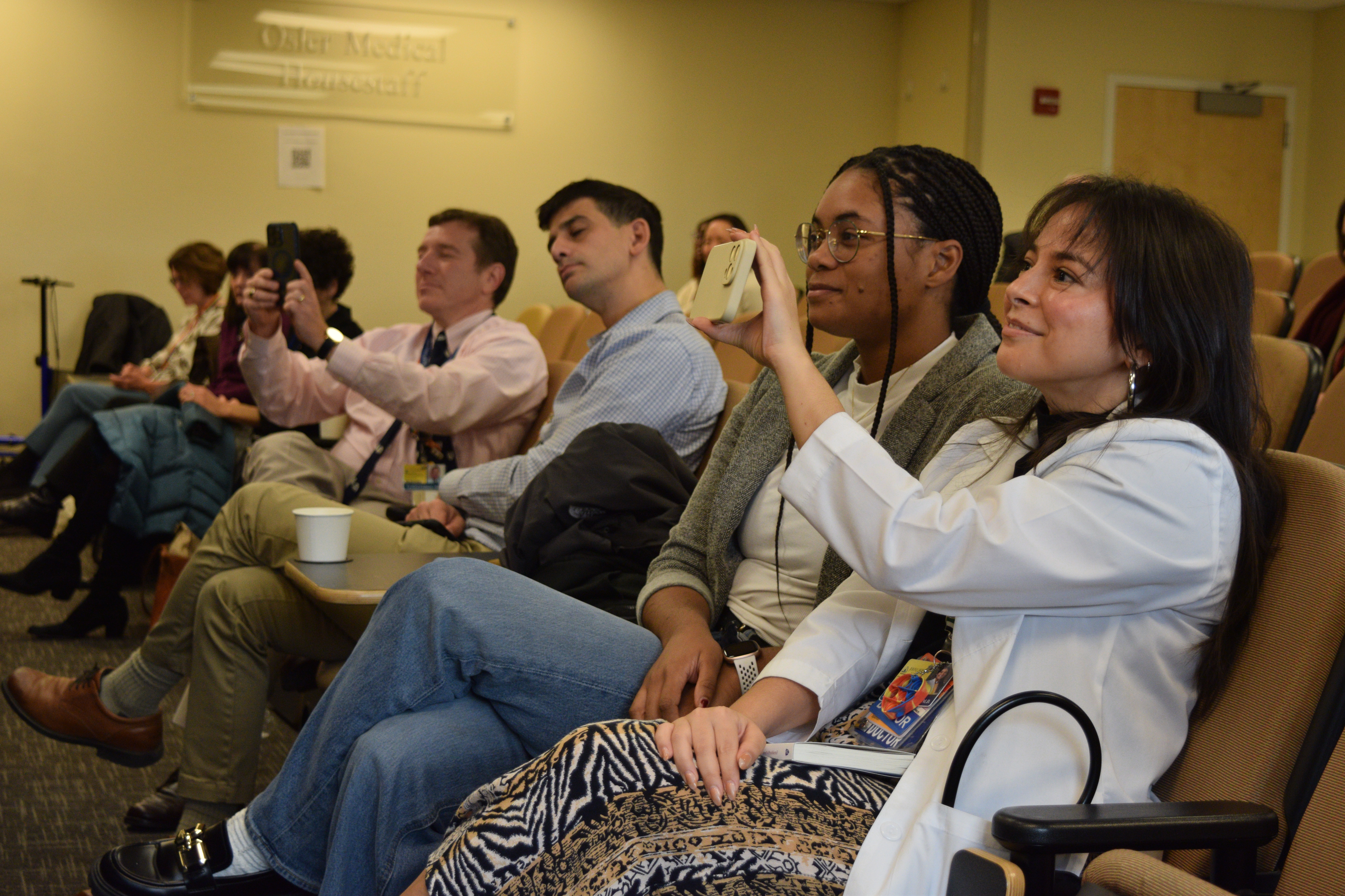 Attendees watch Housestaff winners present.