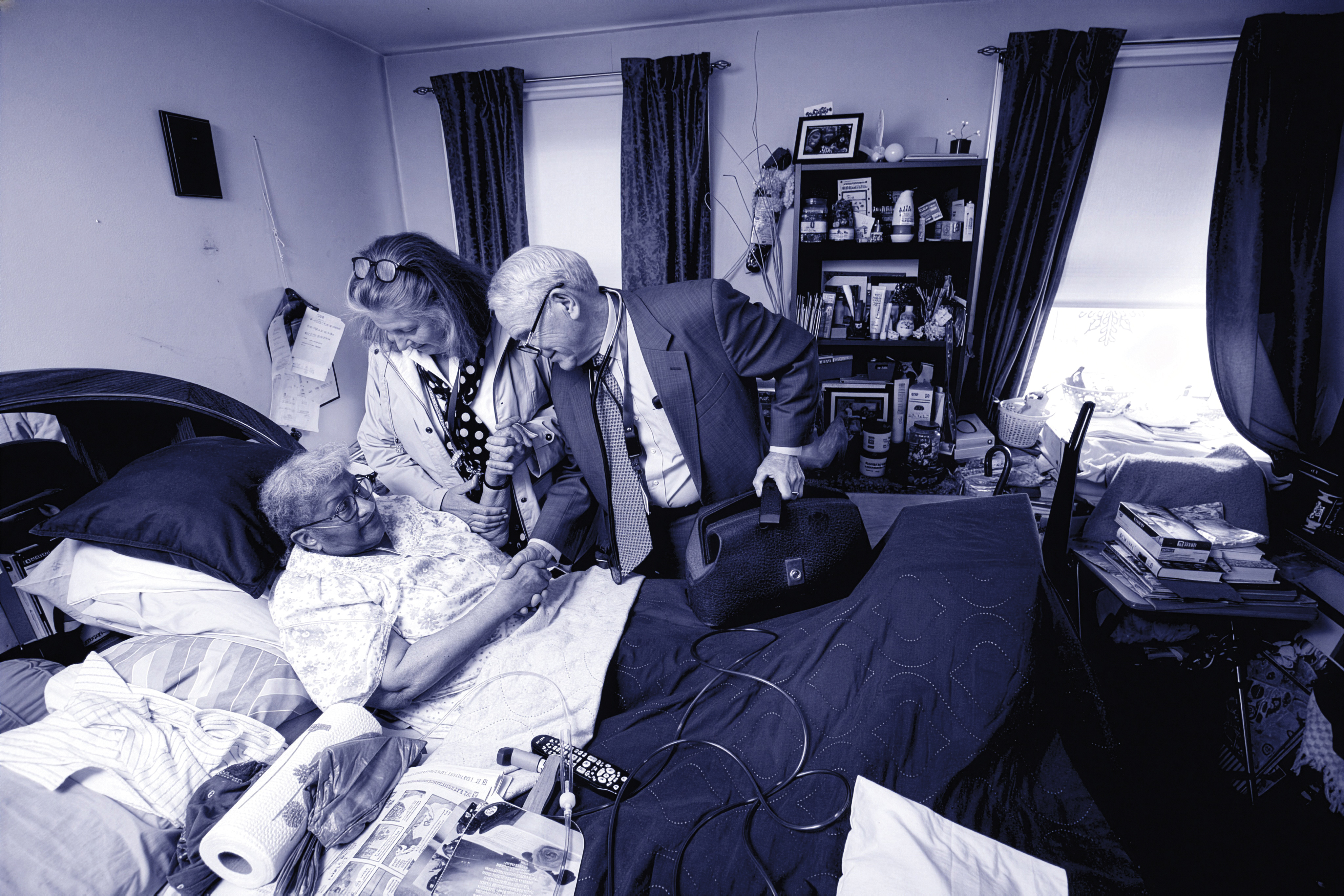 Dr. Burton shaking a patient's hand bedside