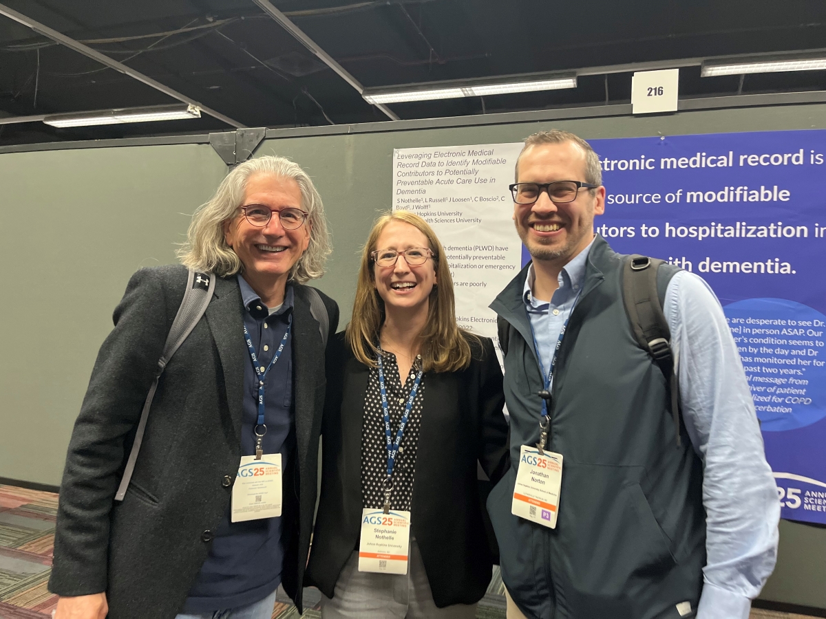 three doctors at a poster session