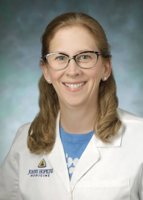 female doctor with blonde hair and glasses