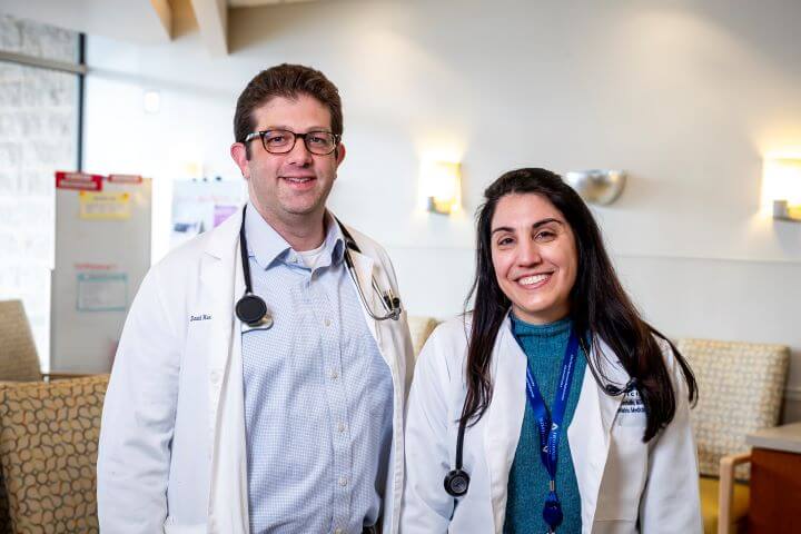 male doctor in glasses, female advanced practice provider