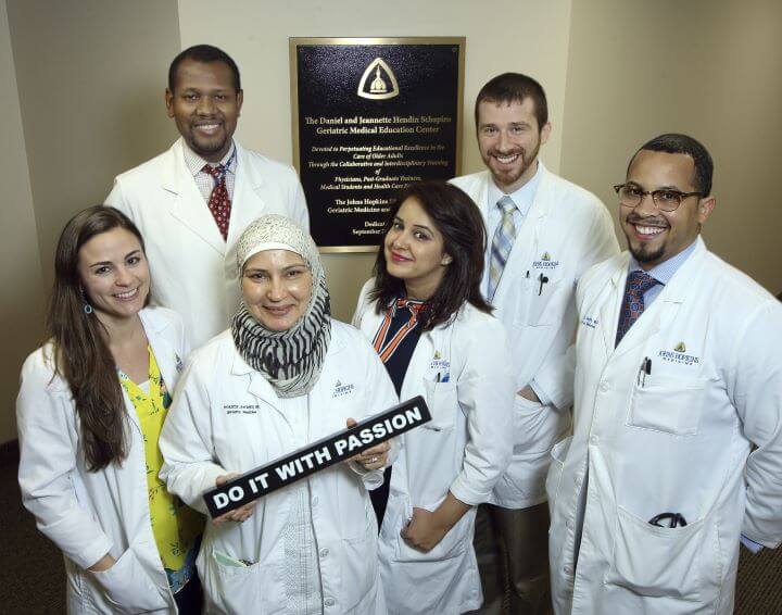 male and female doctors with "Do it with passion" sign