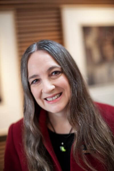 female doctor with long hair and red jacket
