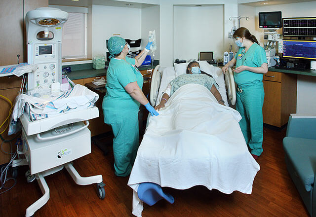 nurses speak to woman in labor
