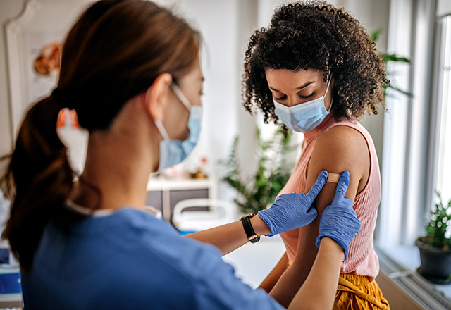a woman getting a vaccine