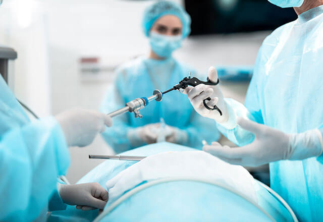 laparoscopic tool is passed to doctor in operating room