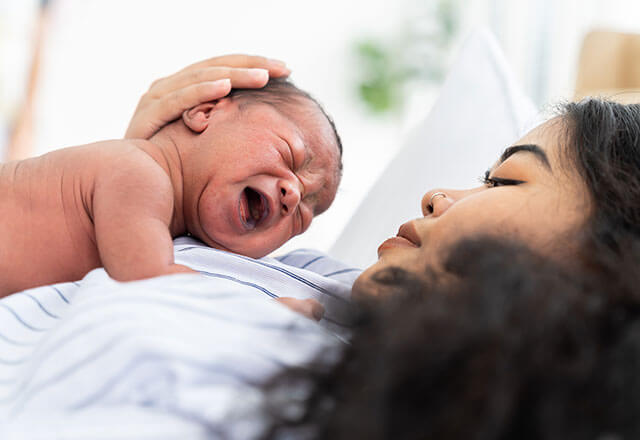 mother holds newborn in hospital