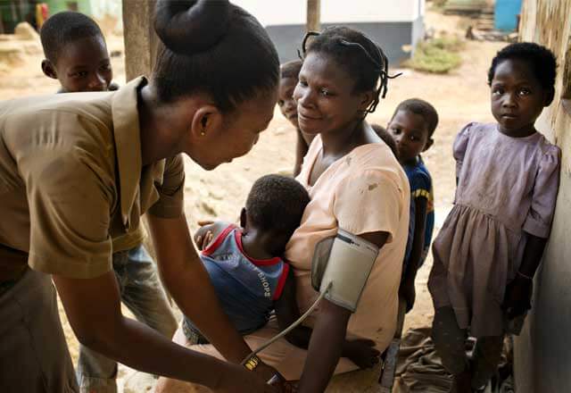 nurse provides aid in African community