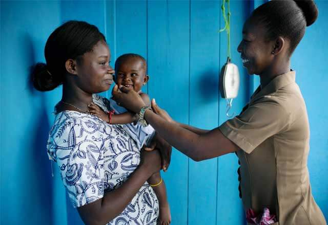 interacting with mother holding child