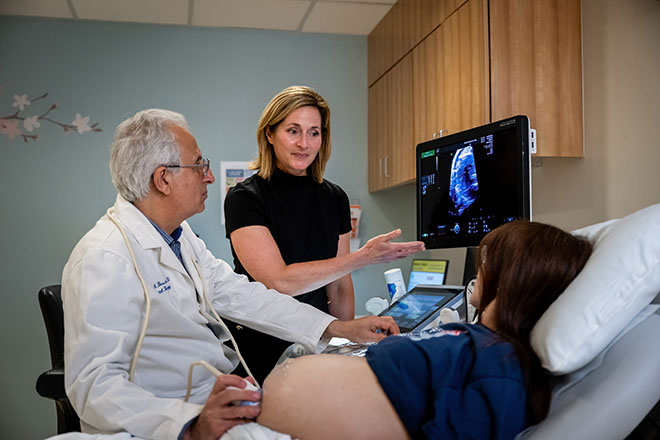Ahmet Baschat and Aimee Armstrong with a pregnant patient