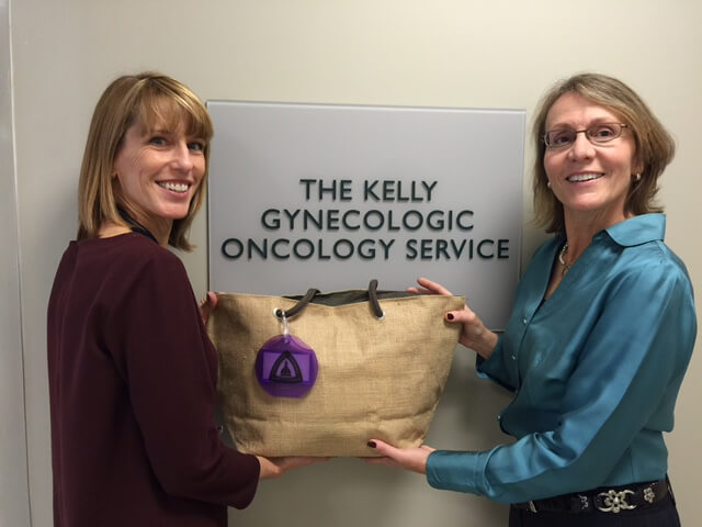 former patients holding a bag from the Kelly's Angels charity