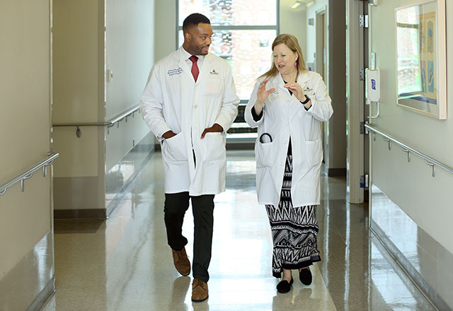 doctors walk and talk in hall