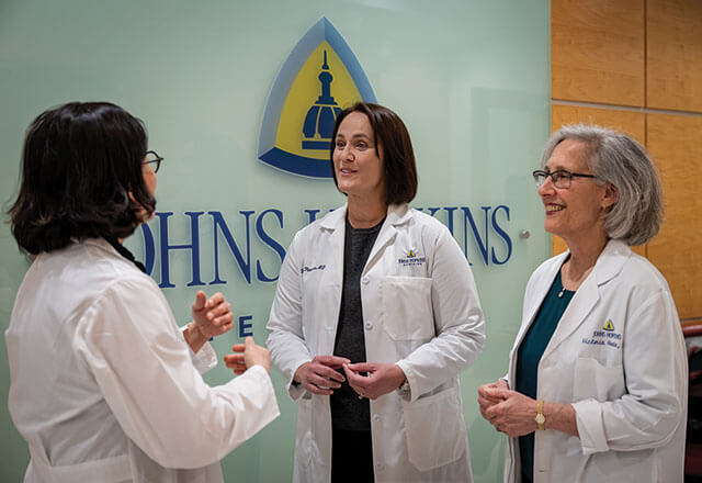 Doctors from the Division of Urogynecology talk during a huddle