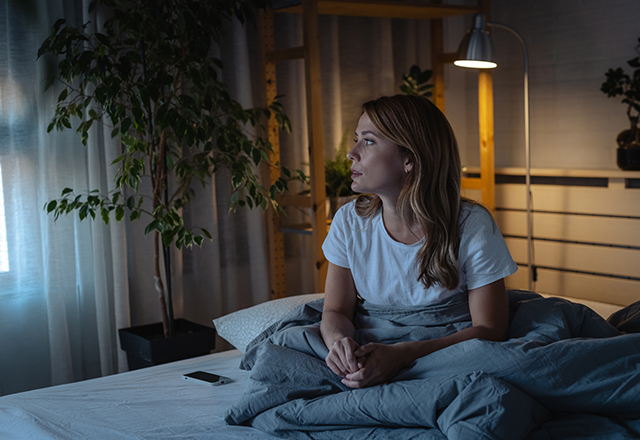 a woman sitting on bed