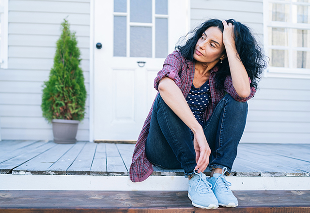 A woman sitting on the porch
