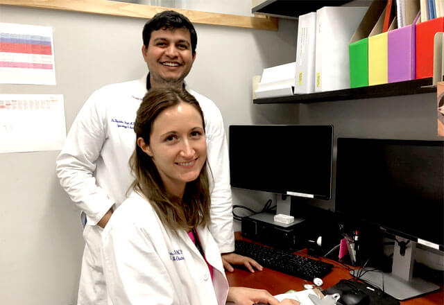 researchers in jones lab stand by desk