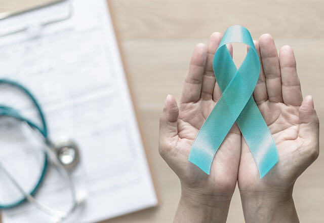 hands hold ovarian cancer awareness ribbon
