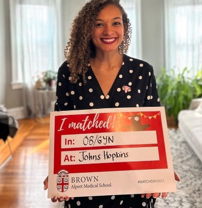 Woman holding acceptance poster.