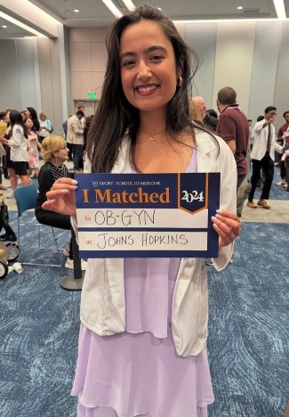 Resident holding acceptance poster.