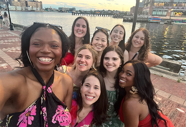 Alumni posing at the harbor