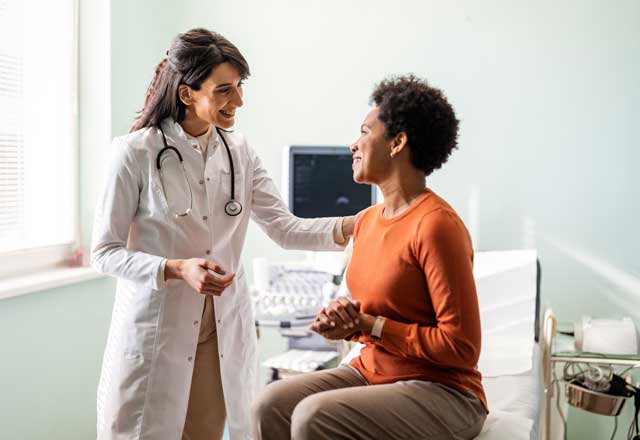 Doctor talking and comforting patient