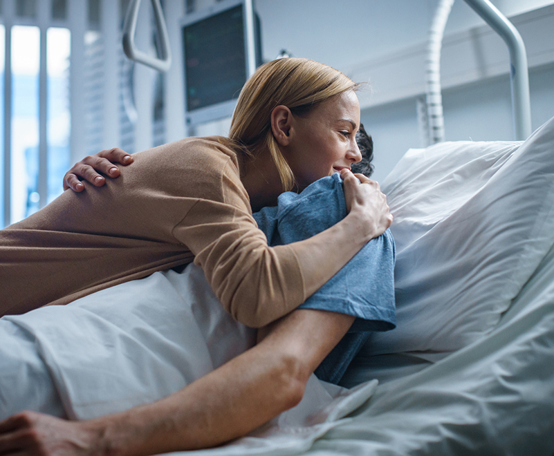 adult congenital heart disease achd - woman embracing man in hospital bed