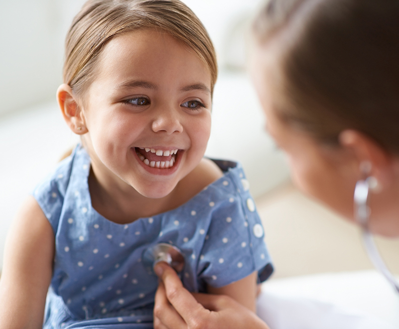 doctor listening to little girl's heart