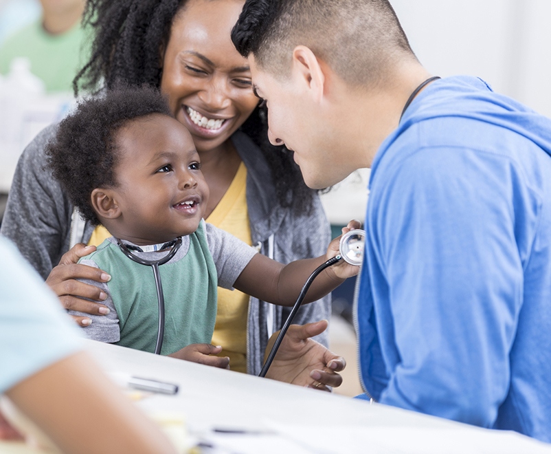 boy playing with nurse's stethoscope