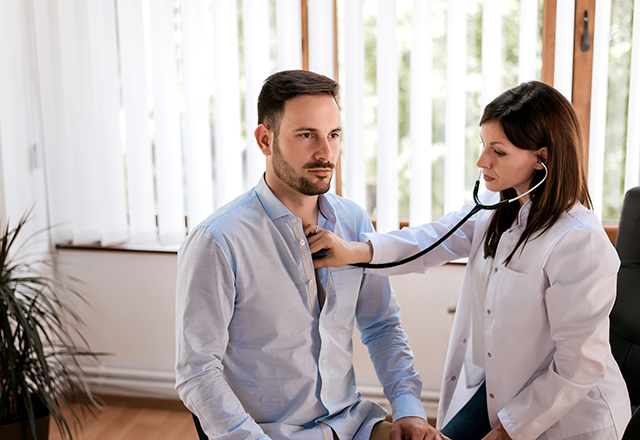 cardiac sarcoidosis - doctor listening to male patient's chest