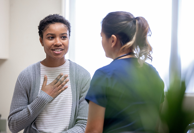 cardiac sarcoidosis - young woman talking to doctor