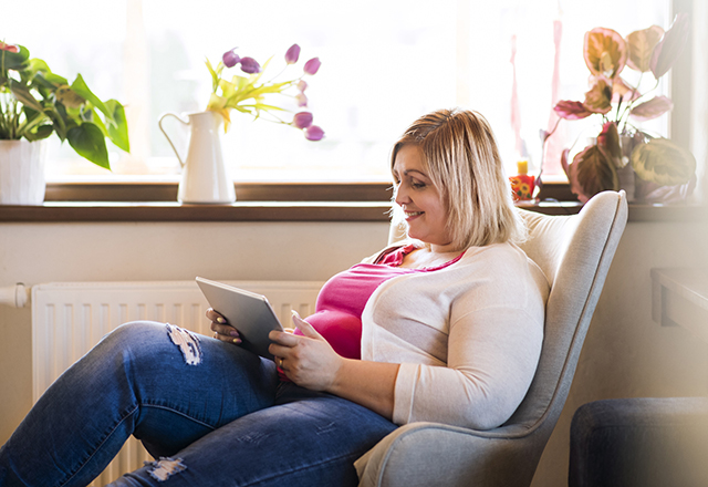 cardiac sarcoidosis - woman smiling using tablet in home