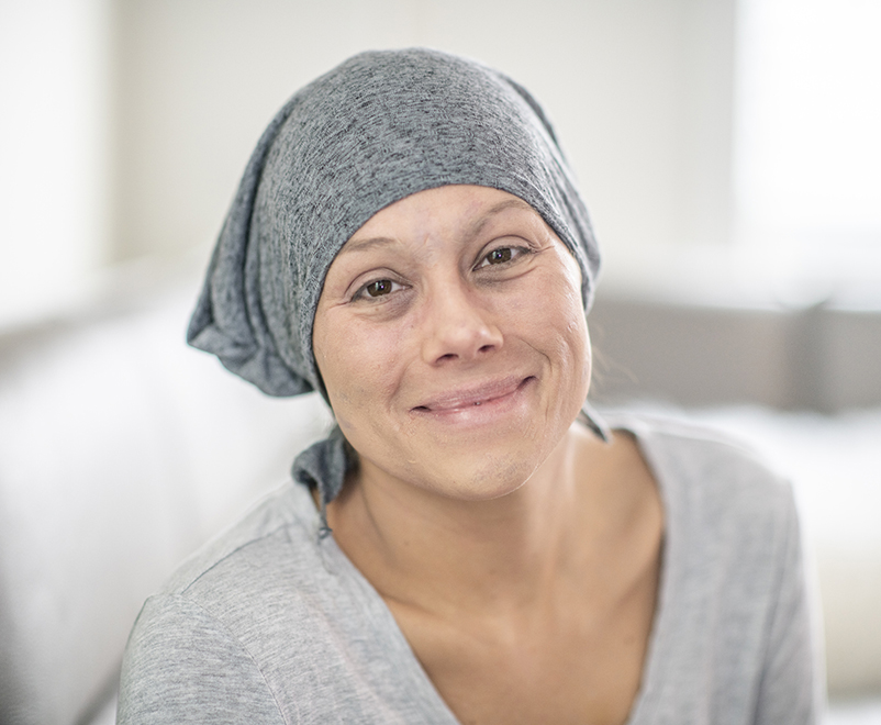 woman wearing scarf looking into camera - cardio-oncology
