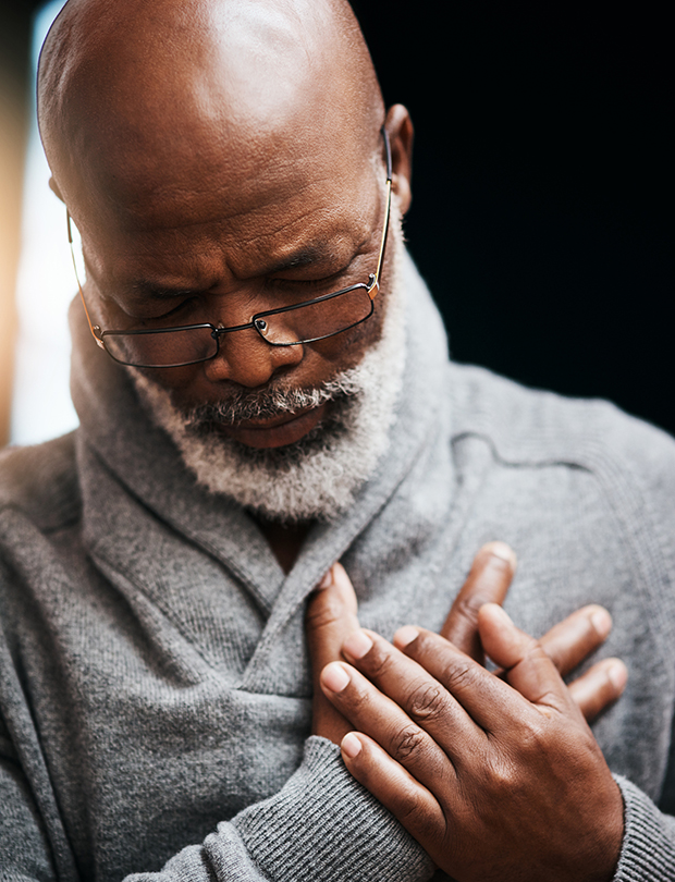 african american man holding chest in pain