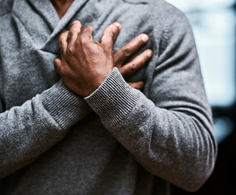 man holding chest