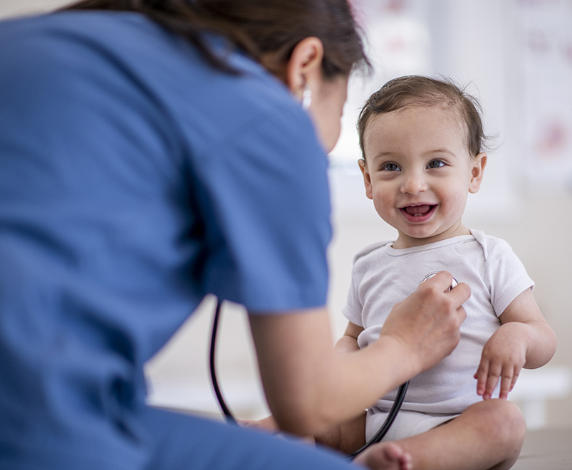doctor listening to baby's chest