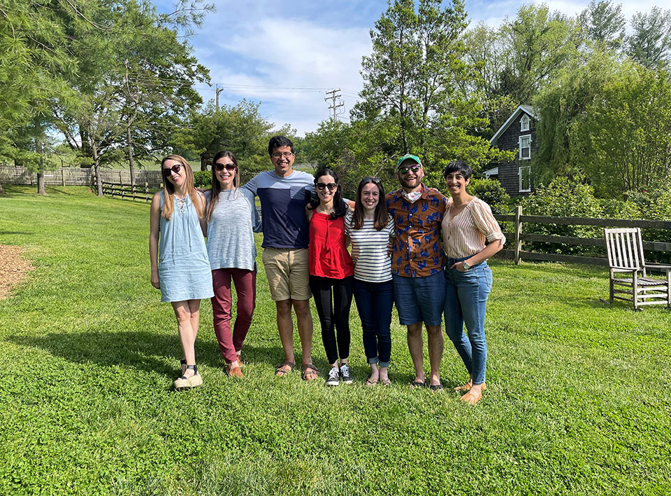 a group of fellows pose outside on a nice day