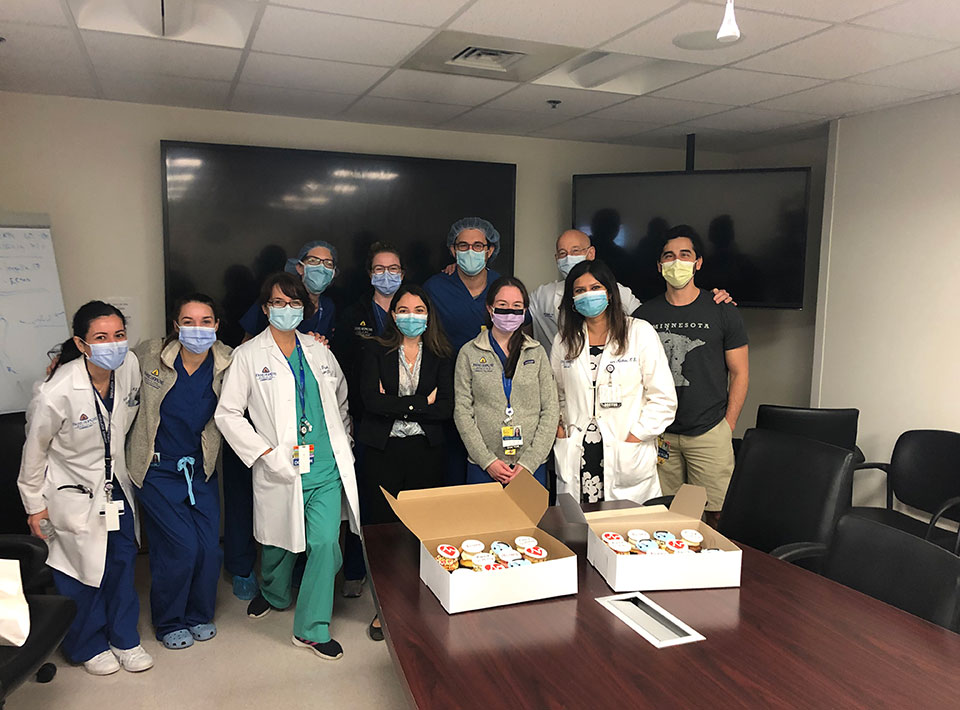 fellows celebrating a colleague's birthday at the hospital with cupcakes