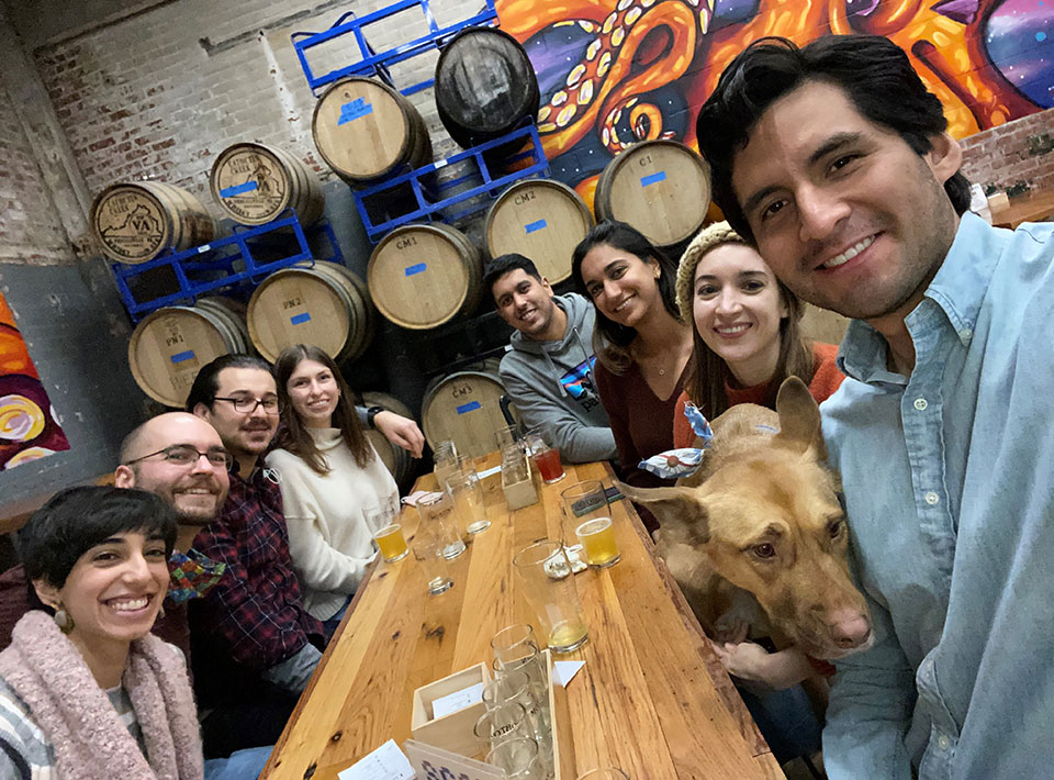 a group of fellows at a brewery with a dog