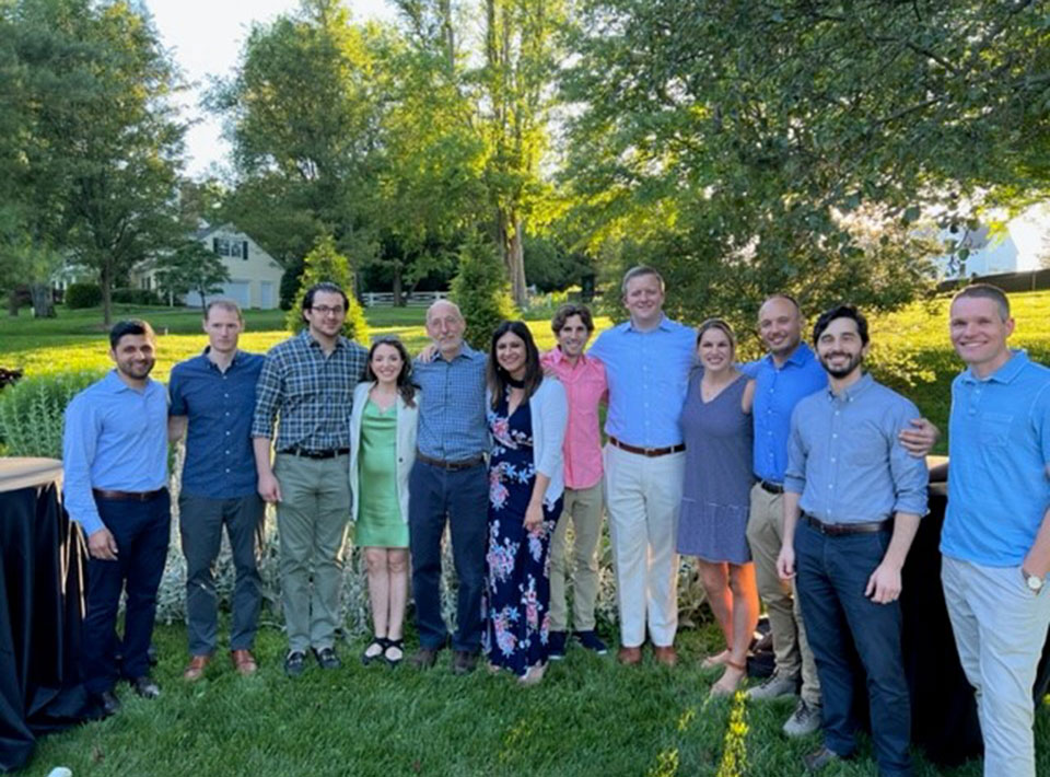 a group of fellows at an outdoor graduation party
