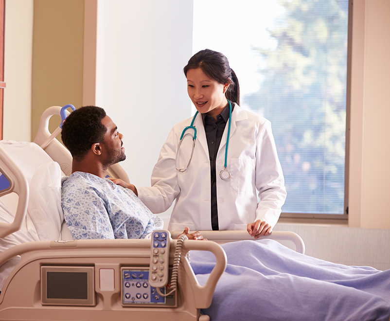 doctor with patient bedside - vascular surgery and endovascular therapy