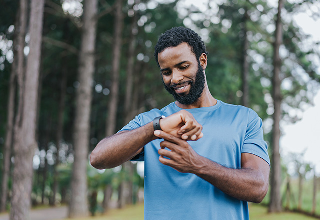 A man looking at a fitness tracker