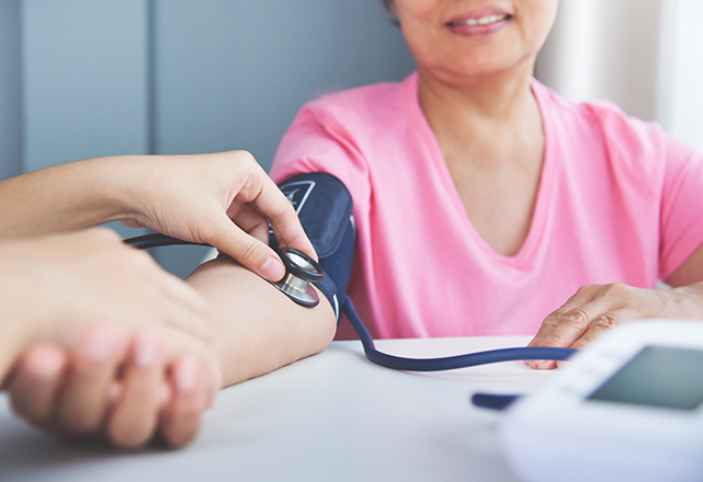 woman getting her blood pressure measured