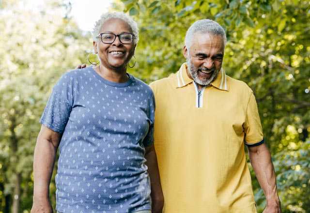 Older couple walking through park