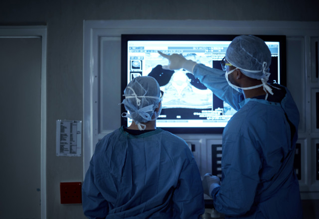 surgeons observing xray in or - heart and vascular institute