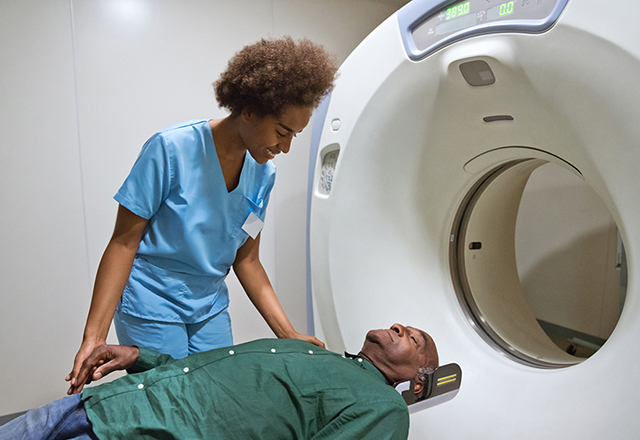 doctor looking at patient during mri - heart and vascular institute