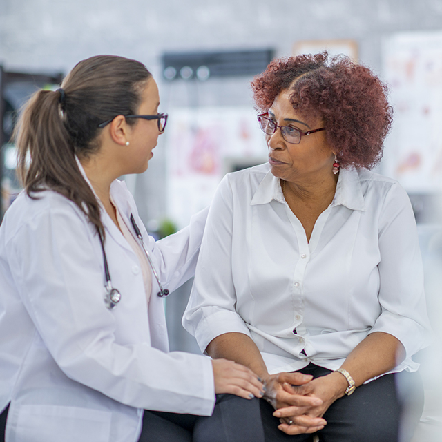 doctor talking to mature female patient - vascular medicine