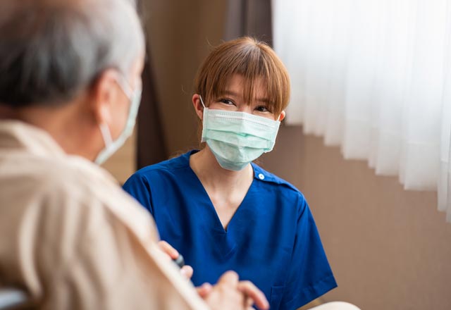 Physician talking to patient wearing a mask