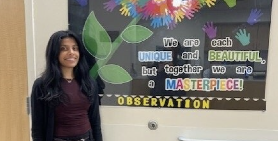 Tanisha posing in front of inspirational poster